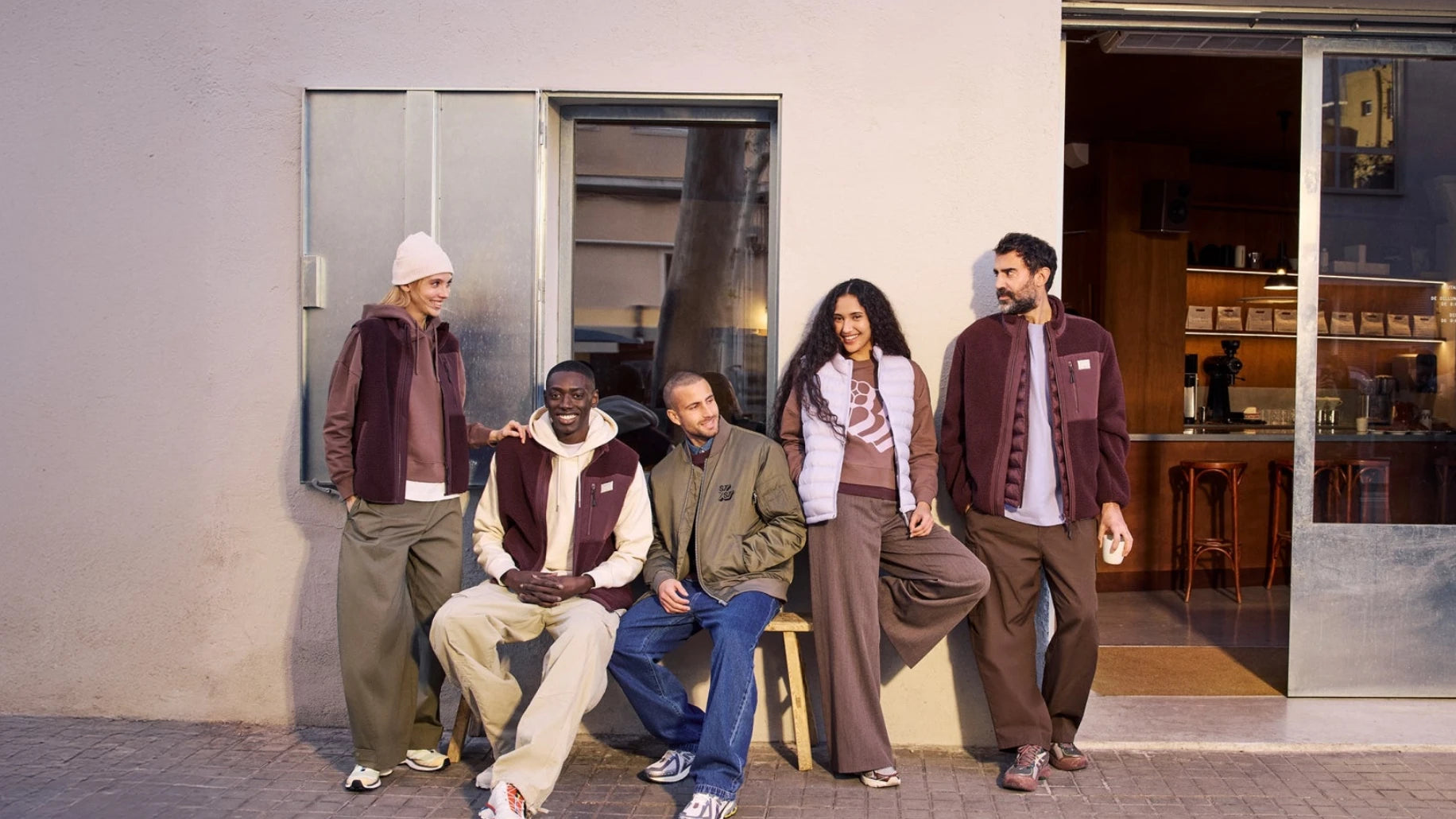 Group of people standing outside a building with a modern interior.