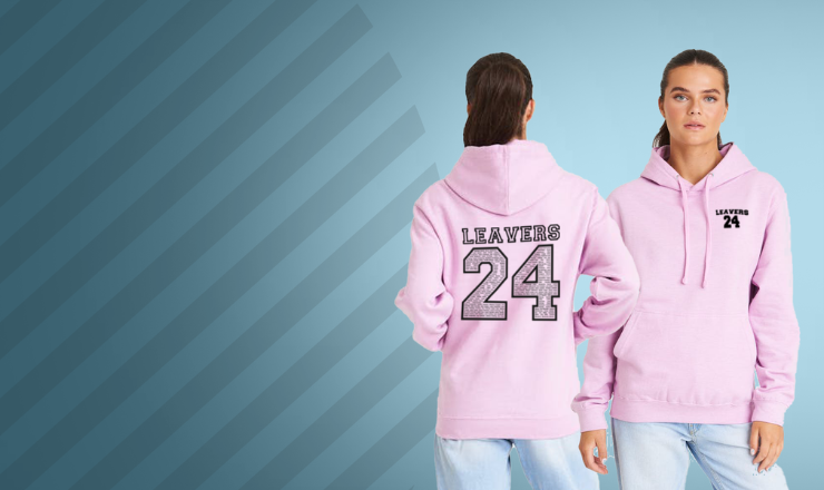 Young adult models a 2024 Leaver's Hoodie against a blue background