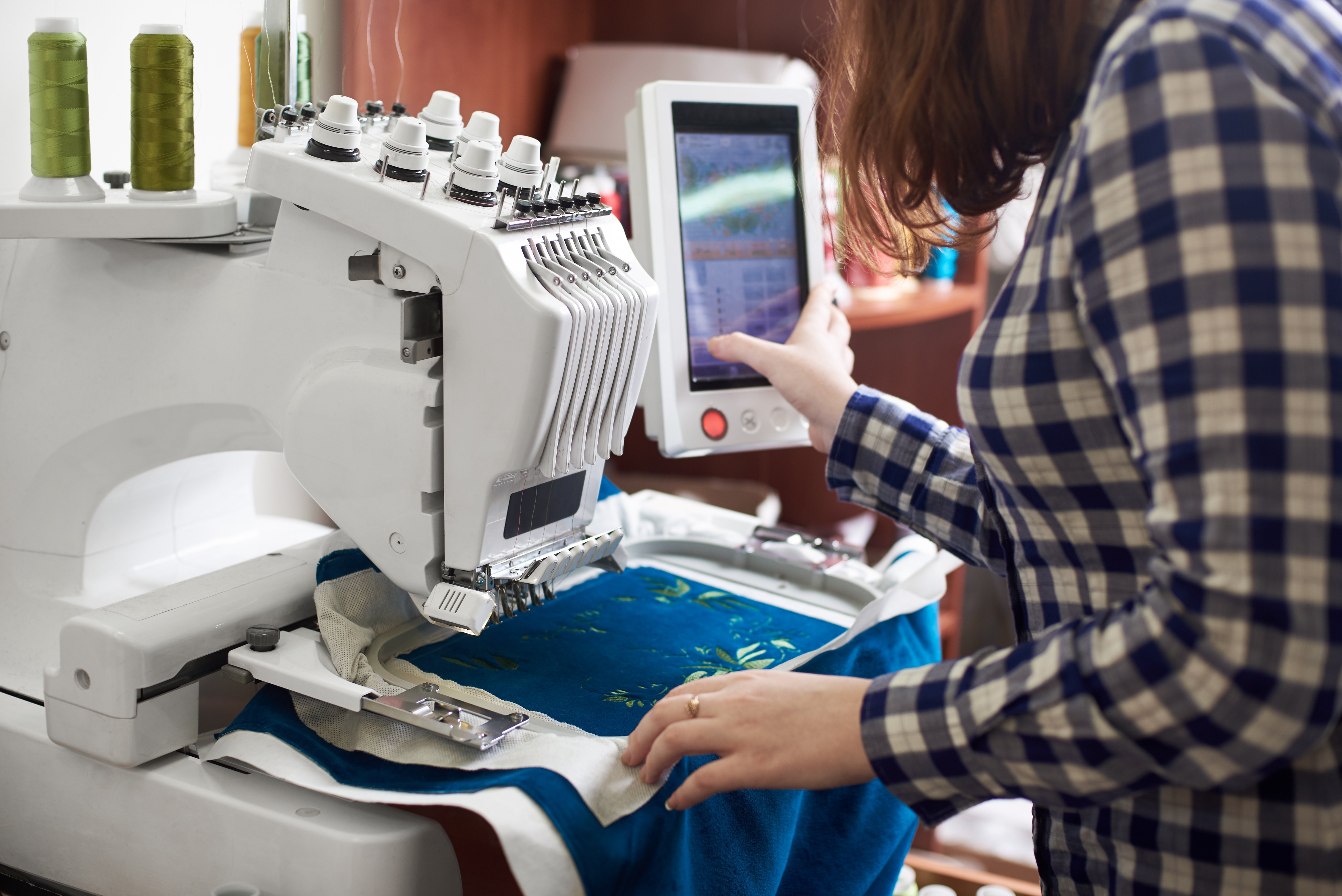 woman using machine embroidery technology